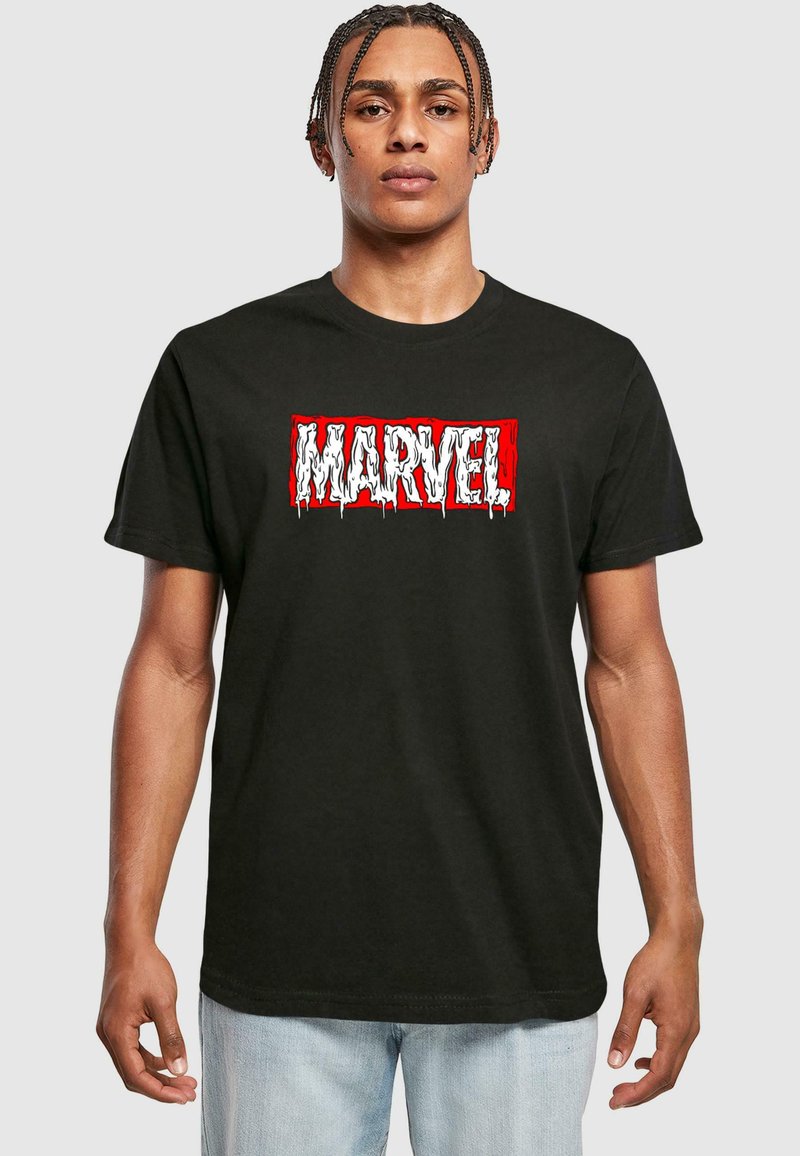Black cotton t-shirt featuring a textured white and red "MARVEL" logo with dripping details, crew neck design, and short sleeves.