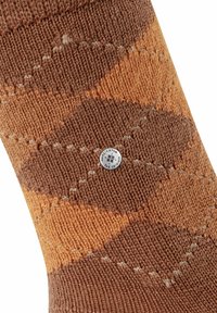 Calzino marrone e arancione con motivo a diamante, realizzato in maglia testurizzata, presenta forme a rombo e un piccolo badge con logo sul lato.