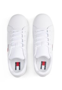 Bílé tenisky s hladkým syntetickým svrškem, zaoblenou špičkou a plochými tkaničkami. Obsahují červenou a modrou akcentní štítek uvnitř a logo na boku.