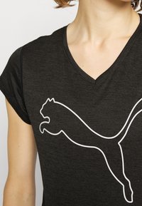 Black short-sleeve T-shirt with a V-neck design featuring a large white Puma logo. The fabric appears soft and slightly textured.