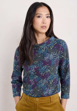 Langärmliges Oberteil in Marineblau mit floralem Muster in Türkis, Gelb und Rot. Glattes Material mit Rundhalsausschnitt und figurbetonter Silhouette.