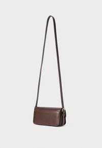 Brown leather crossbody bag with a long strap, rectangular design, visible stitching, and gold-tone hardware accents.