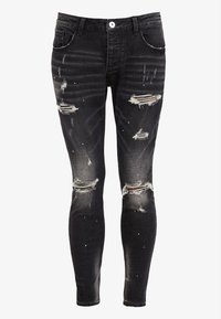 Černé džíny skinny ze surovinového denimu s opotřebovanými záplatami, třepícím se lemem a akcenty v podobě rozstřiku barvy. Pět kapes a přední zapínání na knoflík.