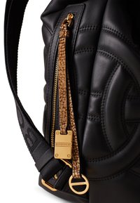 Borsa in pelle nera con design trapuntato, hardware dorato e Zip con motivo a serpente. Tracolla regolabile con dettagli del logo.