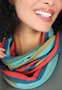 Multicolored infinity scarf featuring bold stripes in turquoise, red, and mustard. Soft, lightweight fabric with a smooth texture.