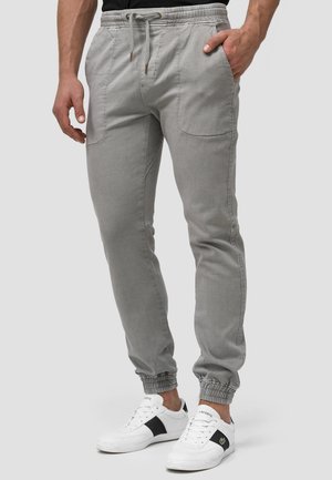 Grijze joggingbroek van lichtgewicht stof, met een elastische tailleband, aantrekkoord, zakken en elastische boorden bij de enkels.