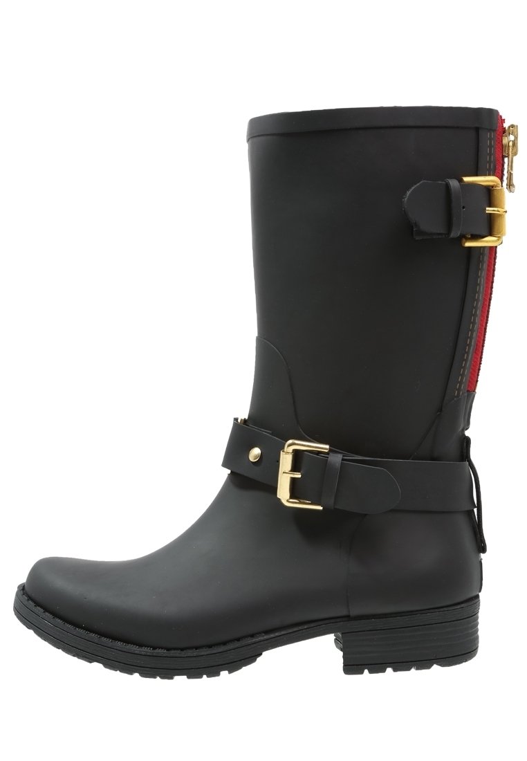 Black rubber boot with a mid-calf height, gold buckle and strap detail, and a red zipper along the back. Textured sole for traction.