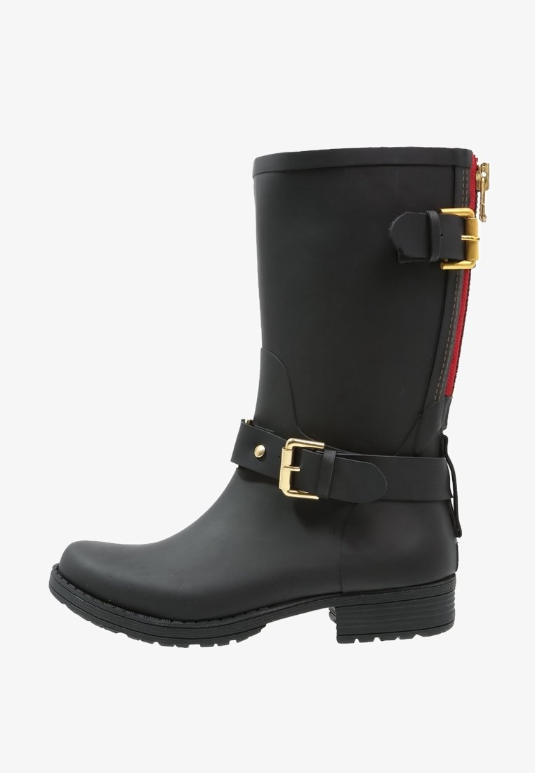 Black rubber boot with a mid-calf height, gold buckle and strap detail, and a red zipper along the back. Textured sole for traction.