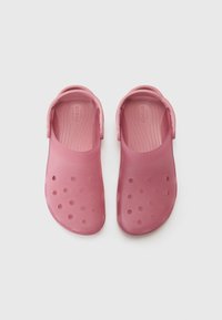Pink rubber clogs with a closed back, open-toe design, and circular cutouts for ventilation. Smooth texture and ribbed insole.
