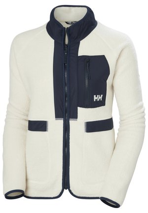 Fleecejacke in Creme mit marineblauen Akzenten. Mit hohem Kragen, Reißverschluss-Brusttasche und zwei Fronttaschen. Kontrastnähte sichtbar.