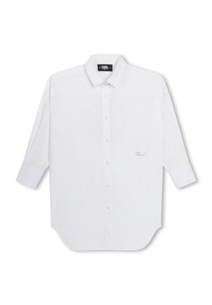 Wit overhemd met lange mouwen, een klassieke kraag en enkele naadstiksels. Voorzien van het geborduurde "Karl" logo aan de linkerkant.