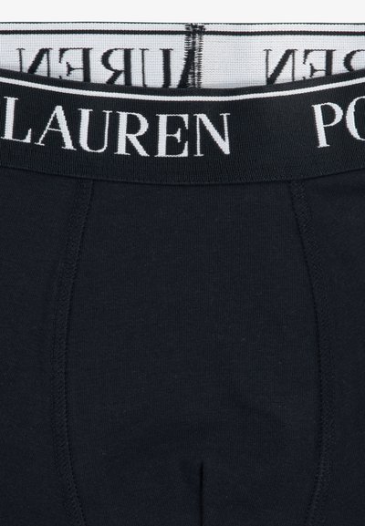 Crne pamučne bokserice s jednostavnim dizajnom, sa bijelim elastičnim pojasom s markom "POLO LAUREN". Glatka tekstura.