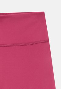 Fitted leggings in vibrant pink, made from smooth, stretchy fabric. Features an elastic waistband with visible stitching.