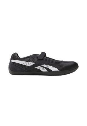 Zapatilla negra de perfil bajo con rayas blancas en ángulo, una sola tira en la parte superior y una suela de goma delgada.