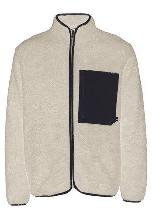 Fleece bunda v krémovej farbe s námorníckou zipsovou kapsou na ľavej hrudi, vysokým golierom a kontrastnými námorníckymi detailmi pozdĺž zipsu a okrajov.