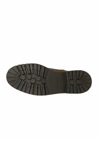 Suola di scarpa in gomma con un motivo a treccia esagonale, strutturata per garantire aderenza. Il logo "wojas" è impresso di lato. Colore: nero.
