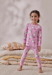 Rozi set pidžame s uzorkom duhova i natpisom "Osjećam se jezivo!" Dugi rukavi, elastične manžete i uske hlače, izrađene od mekanog materijala.
