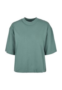 T-shirt vert uni à manches courtes avec col rond, coupe ample et ourlet légèrement raccourci sur fond blanc.