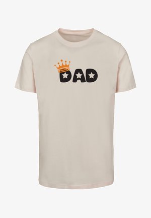 Cream-colored T-shirt made from cotton with a round neckline. Features a black "DAD" graphic with orange crown and two stars.