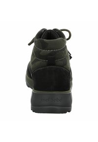 Męskie buty w kamuflażu, wysoko za kostkę, w ciemnozielonym i czarnym zamszu. Posiadają solidną podeszwę, sznurowaną konstrukcję oraz tylną pętlę do łatwego zakładania.