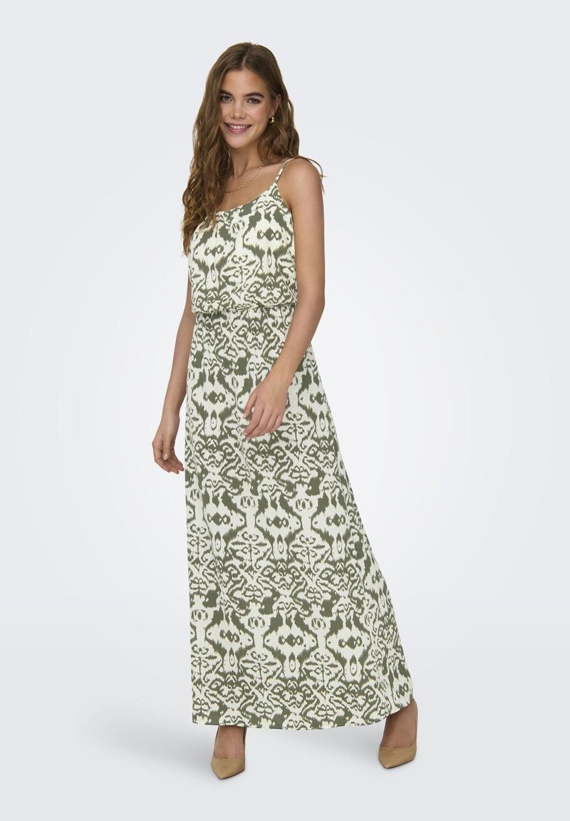 Robe maxi avec un motif ikat vert et blanc, confectionnée en tissu léger. Présente des bretelles fines et une coupe décontractée, accentuée par une taille cintrée.