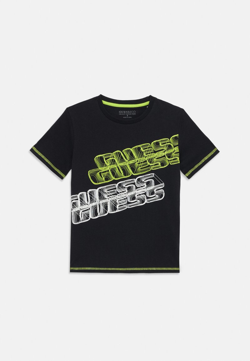 T-shirt en coton noir avec un design de texte "GUESS" en blanc et vert néon, encolure ronde et coutures contrastantes vertes sur les manches et l'ourlet.
