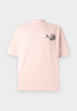 Pink cotton t-shirt with short sleeves and a high neckline featuring a black and red graphic design on the left chest.