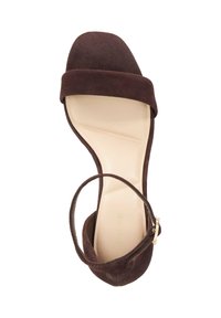 Brown suede strappy sandal with a wide toe strap, delicate ankle strap, and a light beige insole. Features a low heel design.