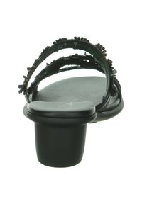 Black sandal with a rounded toe, two thin straps embellished with textured accents, and a short, block heel. Smooth finish.