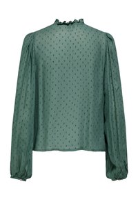 Πράσινη μπλούζα με μακριά μανίκια, διακοσμημένη με ανάγλυφα πουά, με λαιμόκοψη με βολάν και μανσέτες με κουμπιά, εμφανιζόμενη από πίσω.