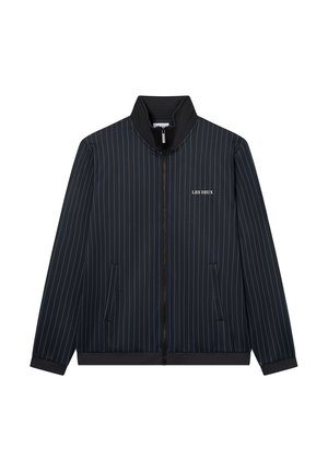 Laivastonsininen vetoketjupaita korkealla kauluksella, jossa on ohuita pystysuoria raitoja ja kaksi etutaskua. "LES DEUX" -logo vasemmassa rinnassa.