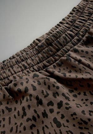 Brauner Stoff mit schwarzem Leopardenmuster, mit einem gerafften elastischen Bund, der ein strukturiertes und flexibles Design schafft.