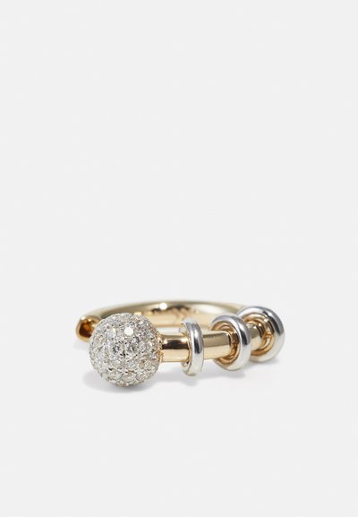 Gold and silver-tone ring featuring a textured spherical accent encrusted with clear crystals, with three smooth metallic bands.