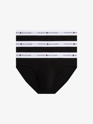 Svarta bomullsboxer med ett vitt elastiskt midjeband som har "TOMMY HILFIGER"-logotypen i röd och blå. Klassisk skärning och mjuk textur.