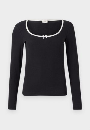 Blusa preta de manga longa com decote quadrado, detalhes em branco e um pequeno laço ao centro. Tecido macio e canelado com um corte justo.