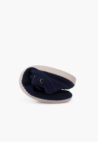 Navy fabric slipper with a soft exterior, rounded shape, and white rubber sole. Features two eyelets for laces and folded design for storage.