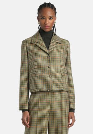 Brown and green checkered cropped jacket with a notched collar, featuring double buttons and two front pockets. Textured fabric detail.