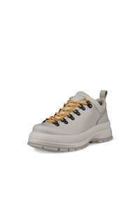 Scarpe da trekking grigio chiaro con suola testurizzata, dotate di lacci gialli e neri, occhielli in metallo e un laccio sul retro per facilitare l'indossamento.