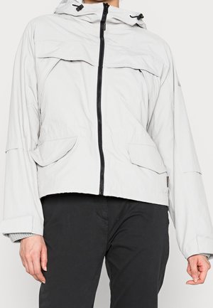 Veste à capuche gris clair avec fermeture zippée sur le devant, deux grandes poches et une coupe décontractée avec des manches légèrement surdimensionnées et une texture mate.