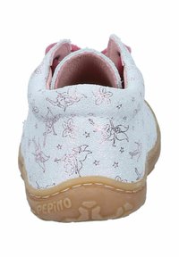 White fabric shoe with pink fairy and flower patterns, low ankle design, soft lining, and a tan rubber sole. Features rounded heel.