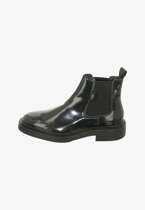 Schwarze Lackleder Chelsea Boots mit elastischen Seitenteilen, einer abgerundeten Zehenpartie und einer strukturierten schwarzen Gummisohle. Mit einer Zuglasche an der Rückseite.