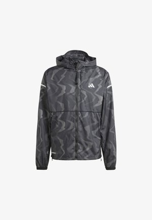 Black windbreaker jacket with a wavy gray pattern, zip front, and hood. Features reflective accents and elastic cuffs for a snug fit.