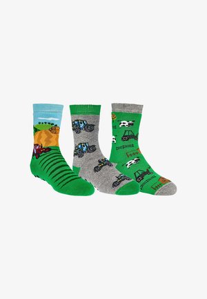 Three colorful children's socks with farm themes, showing tractors, cows, hay bales, fences, and fields in green, gray, and blue tones.
