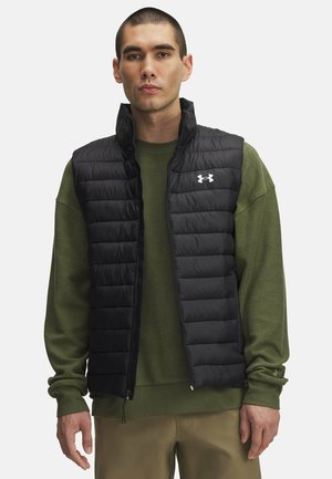 Men's black puffer vest with a quilted design and a front zipper, paired with a green long-sleeve shirt. Features a logo on the chest.