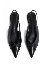 Chaussures noires en cuir à talon ouvert avec un nez pointu et un nœud à l'avant. Texture lisse et design épuré.