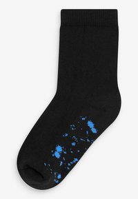 Chaussette de cheville en coton noir avec un poignet côtelé, présentant un motif de gouttes bleues près des orteils et un talon renforcé pour une durabilité accrue.