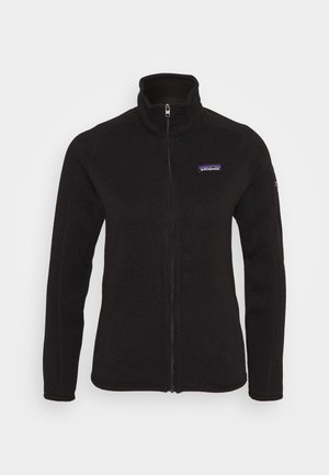 Black fleece jacket with a high collar, full zip, and a purple Patagonia logo on the chest. Features long sleeves and a fitted design.