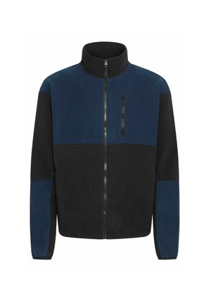 Fleece jacket featuring a high collar, zip closure, and contrasting navy and black panels. Includes two large side pockets and a chest pocket.