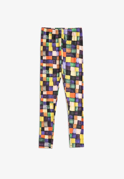 Leggings met een multikleurig geblokt patroon in tinten van geel, oranje, groen, paars, zwart en beige op een witte achtergrond.