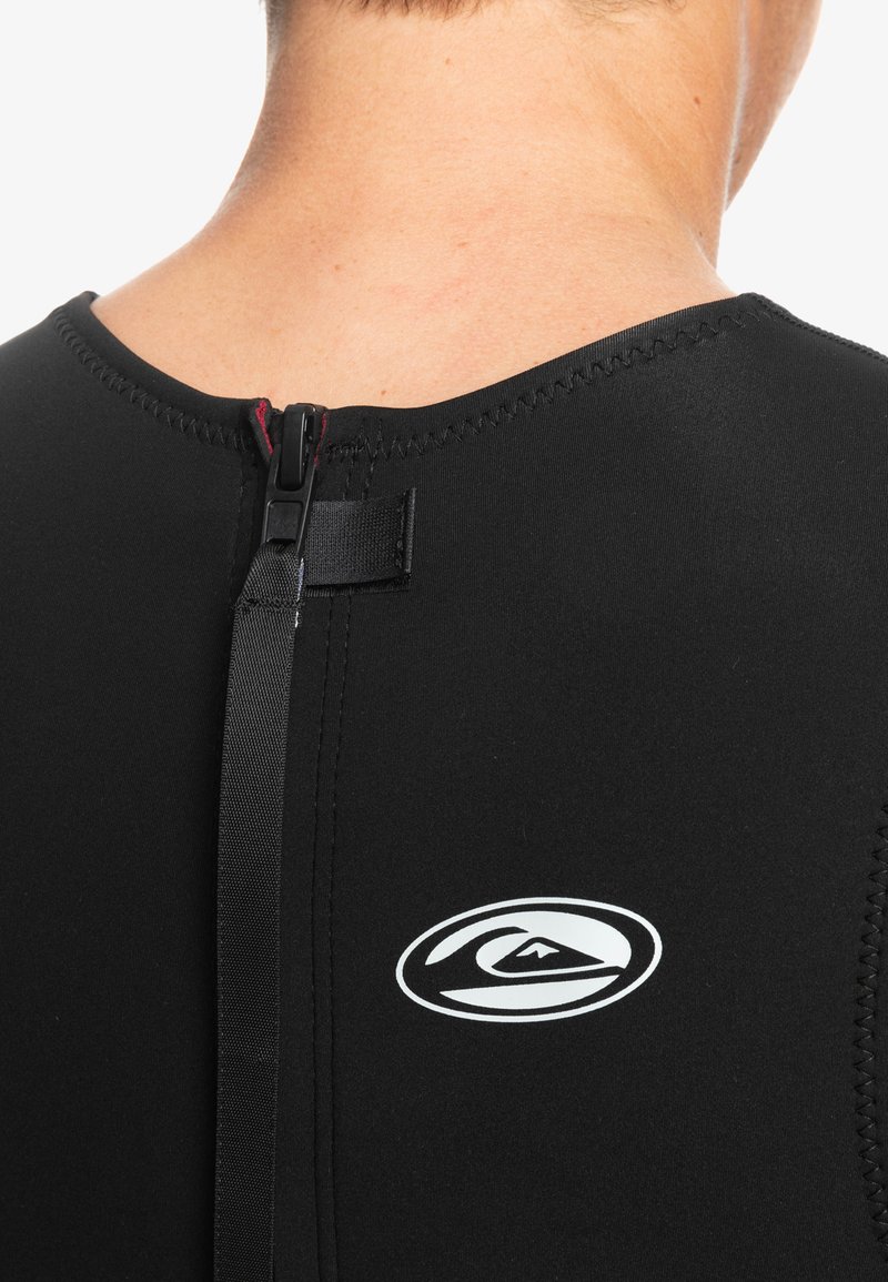 Black wetsuit with a high neck, featuring a back zipper and a small white logo on the left side. Smooth, stretchy material.